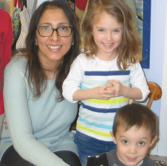 A woman and two children posing for the camera.