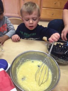A child is mixing something in the bowl